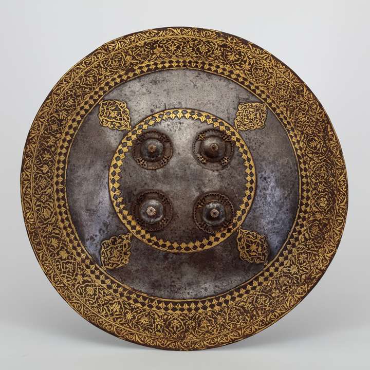 A fine chiselled gold overlaid Indian shield
